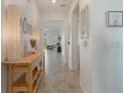 Bright entryway with a console table and light fixtures at 125 Silver Maple Rd, Groveland, FL 34736