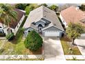 Aerial view of a single Gathering home with a gray roof and landscaping at 12821 Gettysburg Cir, Orlando, FL 32837