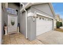 Front entrance with white door, tile flooring, and decorative elements at 12821 Gettysburg Cir, Orlando, FL 32837