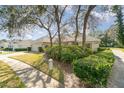 House exterior showcasing a garage and well-maintained landscaping at 1501 Edgewater Dr, Mount Dora, FL 32757