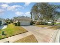 House exterior showcasing a garage and well-maintained landscaping at 1501 Edgewater Dr, Mount Dora, FL 32757