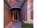 Front entry with a dark-brown door and stone pathway at 1569 Tamarind Rd, Davenport, FL 33896