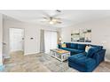 Living room with sectional sofa, coffee table, and tile floors, near hallway at 16133 Pebble Bluff Loop, Winter Garden, FL 34787