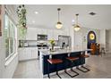 Modern kitchen with white cabinets, granite island, and stainless steel appliances at 16926 Reseda Aly, Winter Garden, FL 34787