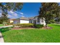 One-story house with light-colored siding, a two-car garage, and a well-manicured lawn at 181 Tall Pines Pass, Kissimmee, FL 34759