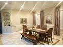 Formal dining room with large table, bench, and neutral decor at 19229 E Peabody St, Orlando, FL 32833