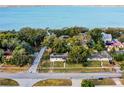 Aerial view showing a house near the waterfront and other homes at 208 S Main Ave, Minneola, FL 34715