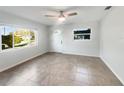 Spacious living room featuring neutral color palette and tile flooring at 211 Palm Pl, Sanford, FL 32773