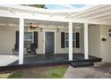 Inviting front porch with ceiling fan and comfortable seating at 2420 Musselwhite Ave, Orlando, FL 32804