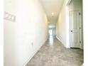 Bright and spacious hallway with tile floors and neutral paint at 245 Lawson Ave, Haines City, FL 33844