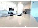 Modern kitchen boasts stainless steel appliances and white cabinets at 245 Lawson Ave, Haines City, FL 33844