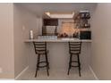 Kitchen breakfast bar with two bar stools at 246 Orienta Point St # 246, Altamonte Springs, FL 32701