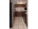 Small kitchen with stainless steel appliances and tiled floor at 246 Orienta Point St # 246, Altamonte Springs, FL 32701