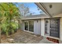 Gray exterior with sliding glass door and dark wood door at 2564 Sheffield Ave, Orlando, FL 32806