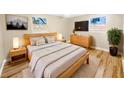 Light-filled main bedroom with hardwood floors and wooden furniture at 2569 Belmont Ave, New Smyrna Beach, FL 32168