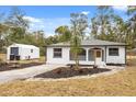 Newly renovated home with a storage building and landscaping at 25753 Vero St, Sorrento, FL 32776