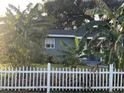 Gray house with white picket fence and tropical landscaping at 28 S Hastings St, Orlando, FL 32835