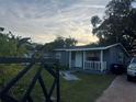 Gray house with white trim, front porch, and landscaped yard at 28 S Hastings St, Orlando, FL 32835