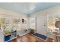 Bright sunroom with hardwood floors and white shutters at 305 S Halifax Dr, Ormond Beach, FL 32176