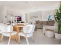 Open concept dining area with modern light wood table and white chairs at 3102 Partington Blvd, Davenport, FL 33837