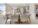 Modern dining room adjacent to kitchen with breakfast bar at 3102 Partington Blvd, Davenport, FL 33837