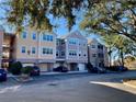 Building exterior featuring three-story townhouses and parking at 3250 Corona Village Way # 302, Orlando, FL 32835
