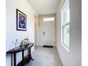 Bright and airy foyer with tile flooring and a console table at 367 Caryota Ct, New Smyrna Beach, FL 32168