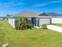 One-story home with gray siding, stone accents, and a two-car garage at 3842 Whitetail Ct, St Cloud, FL 34772