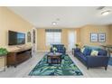 Living room with light walls and blue couches at 5012 Shoreway Loop # 30307, Orlando, FL 32819