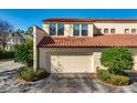 Attached garage with white door and landscaping at 757 Siena Palm Dr # 757, Celebration, FL 34747