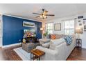 Living room with sectional sofa, large TV, and blue accent wall at 757 Siena Palm Dr # 757, Celebration, FL 34747