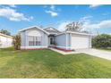 Attractive single-story home featuring a lush green lawn and attached garage at 7812 Wicklow Cir, Orlando, FL 32817