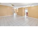 Spacious living room with tile flooring, ceiling fans, and ample natural light at 7812 Wicklow Cir, Orlando, FL 32817