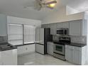 Spacious kitchen with stainless steel appliances and marble-look floors at 9142 Sabal Palm Cir, Windermere, FL 34786