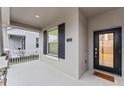 Modern front door with glass panels and a welcoming mat at 11836 Language Way, Orlando, FL 32832