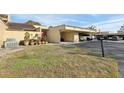 Condo exterior featuring carport and landscaping at 109 Madrid Dr # 109, Casselberry, FL 32707