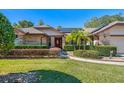 Front view of charming brick home with lush landscaping and a welcoming entrance at 1107 Seafarer Ln, Winter Springs, FL 32708