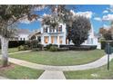 Landscaped lawn, sidewalk, and charming two story home at 11401 Camden Park Dr, Windermere, FL 34786