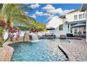 Relaxing pool area with waterfall, spa, and lounge chairs at 11401 Camden Park Dr, Windermere, FL 34786