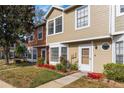 Attractive tan townhouse with landscaping and walkway at 11729 Whitewing Ct, Orlando, FL 32837