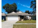 One-story home with a white garage door and well-maintained lawn at 1216 Windward Dr, Apopka, FL 32703