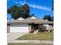 One-story brick house with a white garage door and green lawn at 1216 Windward Dr, Apopka, FL 32703