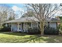 Gray house with mature trees and landscaping at 1821 Stanley St, Longwood, FL 32750