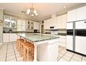 Spacious kitchen with an island, granite countertops, white cabinets, and stainless steel appliances at 1821 Stanley St, Longwood, FL 32750