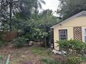 Backyard with lush greenery, a small shed, and a wooden fence at 206 Tangerine Pl, Maitland, FL 32751