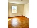 Simple bedroom with hardwood floors and a window offering natural light at 206 Tangerine Pl, Maitland, FL 32751