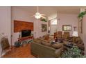 Spacious living room featuring hardwood floors and a large wooden wall decor at 2104 Cranberry Isles Way, Apopka, FL 32712