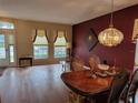 Bright dining room with hardwood floors and elegant chandelier at 2310 Grasmere Cir, Clermont, FL 34711