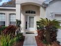 Inviting front entrance with lush landscaping and walkway at 2310 Grasmere Cir, Clermont, FL 34711