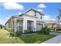 Two-story house with a two-car garage, landscaping, and flamingo decor at 2709 Greenlands St, St Cloud, FL 34772